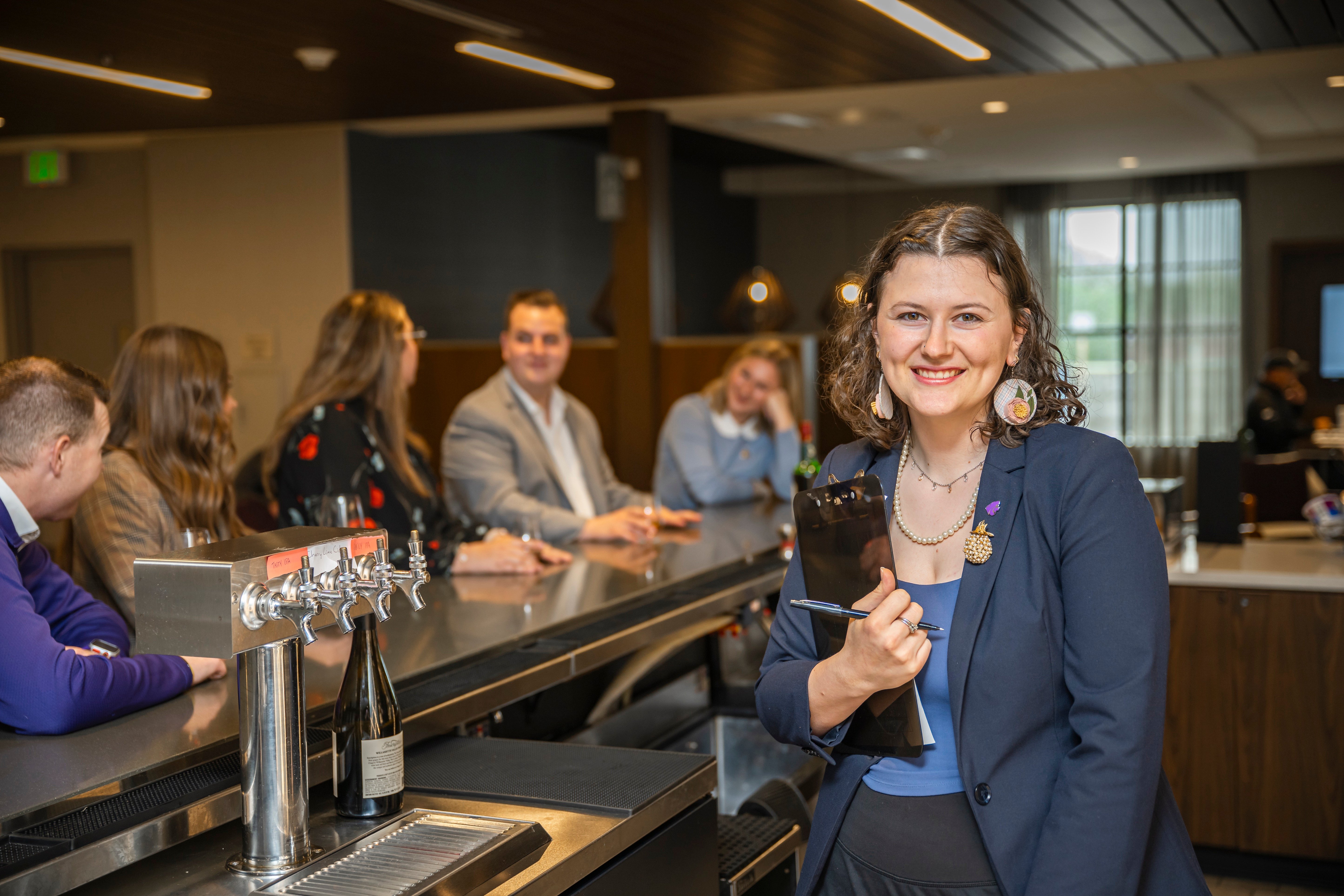 Manager with Clipboard by Bar - Hospitality MHK